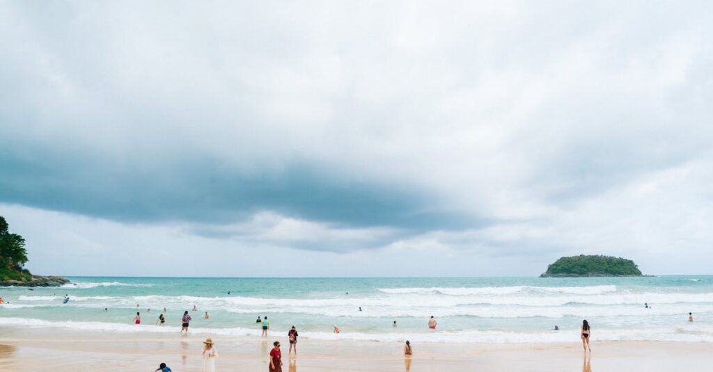 Relaxing day at Kata Beach, Phuket with people enjoying the ocean and beautiful scenery.